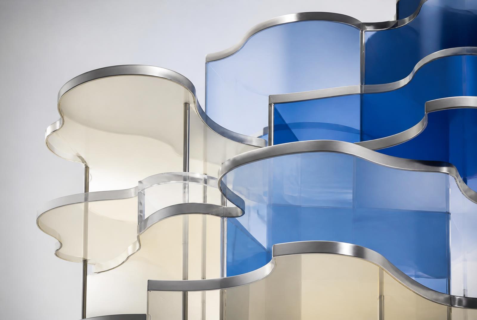 Layered translucent ivory and cobalt glass panels with brushed metal edges, an abstract representation of cloud layers